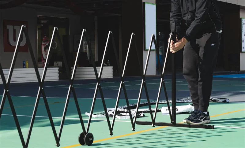 one person is install a portable pickleball net